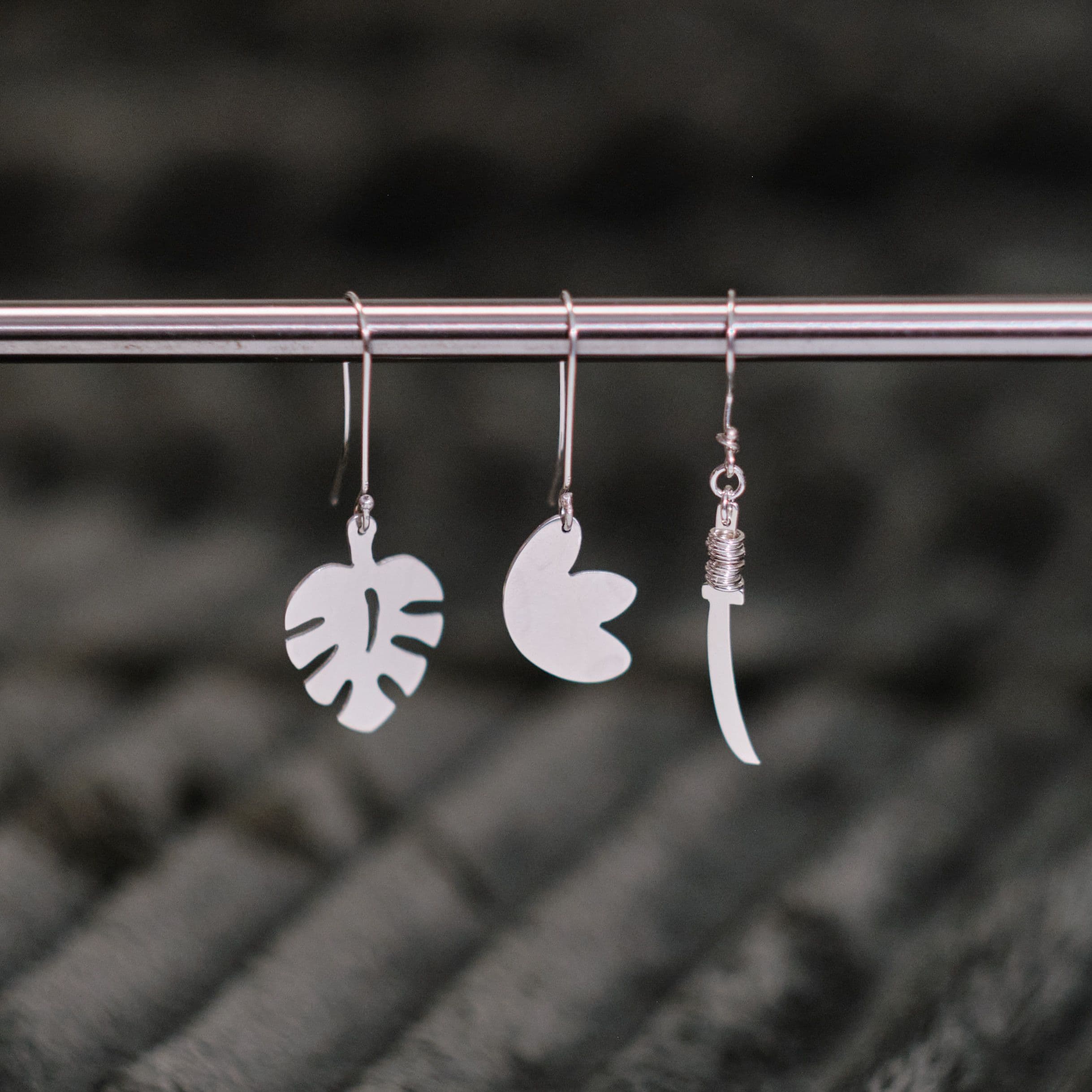 Earrings hanging on a metal rod